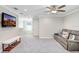 Upstairs living room with seating, tv, and an open doorway at 5407 Tagalong Pl, Apollo Beach, FL 33572