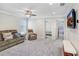 Second-floor living area with plush carpeting and media setup at 5407 Tagalong Pl, Apollo Beach, FL 33572