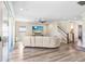 Contemporary living room with a large sliding glass door, sleek flooring, and staircase to the upper level at 5407 Tagalong Pl, Apollo Beach, FL 33572