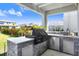 An outdoor kitchen features a built-in grill, stainless steel appliances and counterspace, perfect for al fresco dining at 5407 Tagalong Pl, Apollo Beach, FL 33572