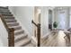 Inviting interior view highlighting a carpeted staircase, modern lighting, and elegant flooring at 5407 Tagalong Pl, Apollo Beach, FL 33572
