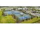 A community includes several well-maintained tennis courts, shaded seating, and lush landscaping for sports and recreation at 5407 Tagalong Pl, Apollo Beach, FL 33572