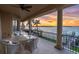 Covered balcony with seating and stunning water views, perfect for relaxing and entertaining at 700 126Th Ave, Treasure Island, FL 33706