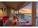 Relaxing balcony with comfortable seating, a fire pit, and an expansive view of the water at sunset at 700 126Th Ave, Treasure Island, FL 33706