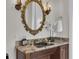 Elegant powder room with a stylish black sink, granite countertop, and ornate gold accents for a luxurious touch at 700 126Th Ave, Treasure Island, FL 33706