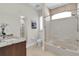 Bathroom with vanity and tub shower featuring large window and natural light at 700 126Th Ave, Treasure Island, FL 33706