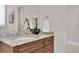 Bathroom features granite countertops, a white sink, and a decorative floral arrangement at 700 126Th Ave, Treasure Island, FL 33706