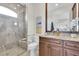 Bathroom with granite countertop vanity, glass-enclosed shower, and neutral tones at 700 126Th Ave, Treasure Island, FL 33706