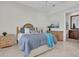 Bedroom features neutral decor with a view to an ensuite bathroom and granite topped vanity at 700 126Th Ave, Treasure Island, FL 33706