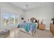 Bright bedroom features a shuttered window, ceiling fan, and beach-themed décor at 700 126Th Ave, Treasure Island, FL 33706