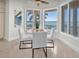 Inviting breakfast nook with large bay windows providing stunning water views at 700 126Th Ave, Treasure Island, FL 33706