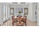 Charming dining area with tray ceiling, plantation shutters, art and seating for eight at 700 126Th Ave, Treasure Island, FL 33706