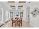 Elegant dining room with decorative tray ceiling, shutters, artwork, and marble floors at 700 126Th Ave, Treasure Island, FL 33706