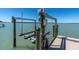 Boat dock features lift system on the water with serene water views at 700 126Th Ave, Treasure Island, FL 33706