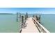 Private dock with boat lift extending into calm water, perfect for boating enthusiasts at 700 126Th Ave, Treasure Island, FL 33706