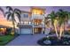 Gorgeous exterior with a circular driveway and meticulously manicured landscaping that complements the stylish architecture at 700 126Th Ave, Treasure Island, FL 33706