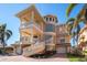 Stunning three-story home with balconies, a spiral staircase, and a unique turret design at 700 126Th Ave, Treasure Island, FL 33706