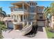 Gorgeous home featuring a curved staircase, balconies, and a terracotta roof at 700 126Th Ave, Treasure Island, FL 33706