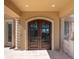 Stunning wooden double front doors with decorative wrought iron detailing at 700 126Th Ave, Treasure Island, FL 33706