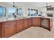 Gourmet kitchen with stainless steel appliances, custom cabinets, and a view of the living room and water at 700 126Th Ave, Treasure Island, FL 33706