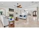 Elegant living area with a fireplace and an open floor plan leading to a grand staircase at 700 126Th Ave, Treasure Island, FL 33706
