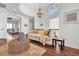 Bright living room showcases a large window, chandelier, hardwood floors, and access to a balcony at 700 126Th Ave, Treasure Island, FL 33706