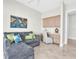 Cozy living space featuring a plush gray sofa, decorative pillows, and a built-in desk with storage at 700 126Th Ave, Treasure Island, FL 33706