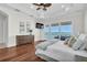 Bright primary bedroom with hardwood floors and access to a balcony overlooking the water at 700 126Th Ave, Treasure Island, FL 33706