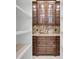 Walk-in pantry showing granite countertop, wooden cabinets, and open shelving at 700 126Th Ave, Treasure Island, FL 33706