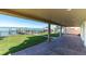 Covered patio features a brick floor, backyard access, and gorgeous water views at 700 126Th Ave, Treasure Island, FL 33706
