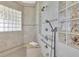 Tiled shower with bench and multiple shower heads with glass block accents at 700 126Th Ave, Treasure Island, FL 33706