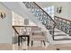 Elegant staircase features wrought iron railing, glass block window, and decorative wall sconces at 700 126Th Ave, Treasure Island, FL 33706