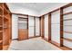 Organized walk-in closet with built-in shelving and drawers in hardwood finish at 700 126Th Ave, Treasure Island, FL 33706