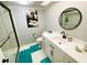 Modern bathroom with stylish vanity, sleek round mirror, and glass-enclosed shower at 700 Starkey Rd # 821, Largo, FL 33771