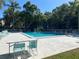 Refreshing community pool with lounge chairs and lush landscaping around at 700 Starkey Rd # 821, Largo, FL 33771