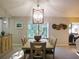 Bright dining room featuring large window, vaulted ceiling, and stylish light fixture at 700 Starkey Rd # 821, Largo, FL 33771