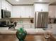 Stylish kitchen featuring stainless steel appliances, white cabinets, and modern countertops at 700 Starkey Rd # 821, Largo, FL 33771