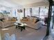 Open-concept living room and dining area with lots of natural light and sliding doors to patio at 700 Starkey Rd # 821, Largo, FL 33771