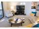 Cozy living room featuring a striped chair, entertainment center, and comfortable sofa at 700 Starkey Rd # 821, Largo, FL 33771