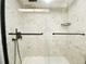 Modern shower features elegant marble tile, glass door, and sleek black fixtures at 700 Starkey Rd # 821, Largo, FL 33771