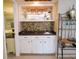 Stylish wet bar featuring modern cabinetry, a sink, and an elegant display shelf at 700 Starkey Rd # 821, Largo, FL 33771