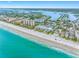 Scenic coastal view of a beach, homes, buildings, and a lake in a vibrant community at 812 Gulf # 3, Indian Rocks Beach, FL 33785