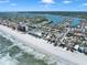Stunning aerial view of the coastal community with homes along the beach and bay, perfect for boating at 812 Gulf # 3, Indian Rocks Beach, FL 33785