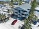 Aerial view of the property with large balconies, covered parking, and mature palm trees in the yard at 812 Gulf # 3, Indian Rocks Beach, FL 33785