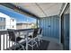 Relax on this cozy balcony with blue siding, a bar-height table and views of the neighborhood at 812 Gulf # 3, Indian Rocks Beach, FL 33785