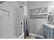 Clean bathroom with a shower/tub combo, white subway tile, and coastal-themed artwork at 812 Gulf # 3, Indian Rocks Beach, FL 33785