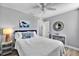 Cozy bedroom featuring soft white bedding, coastal decor, and ample natural light at 812 Gulf # 3, Indian Rocks Beach, FL 33785