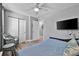Well-lit bedroom with a ceiling fan, tv and closet, and tasteful decor and gray wall paint at 812 Gulf # 3, Indian Rocks Beach, FL 33785