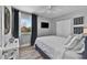 Comfortable bedroom with sleek TV, soft white bedding, and ample natural light at 812 Gulf # 3, Indian Rocks Beach, FL 33785