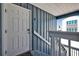 Charming entrance to the home with a weathered door, blue siding and partial view of the neighborhood at 812 Gulf # 3, Indian Rocks Beach, FL 33785